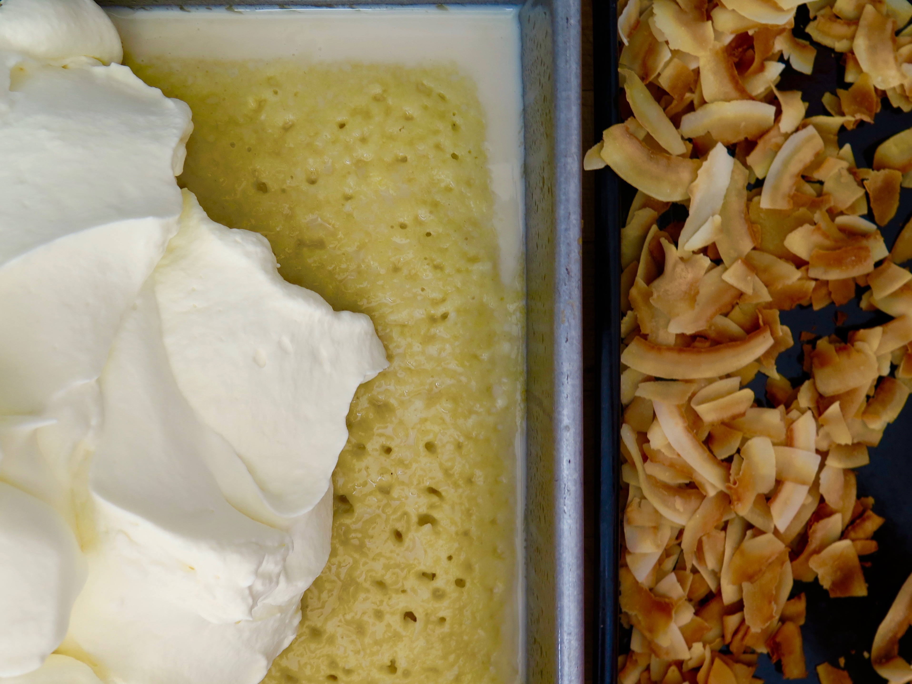 spreading the coconut whipped cream on the coconut tres leches cake Coconut Tres Leches | Jessie Sheehan Bakes