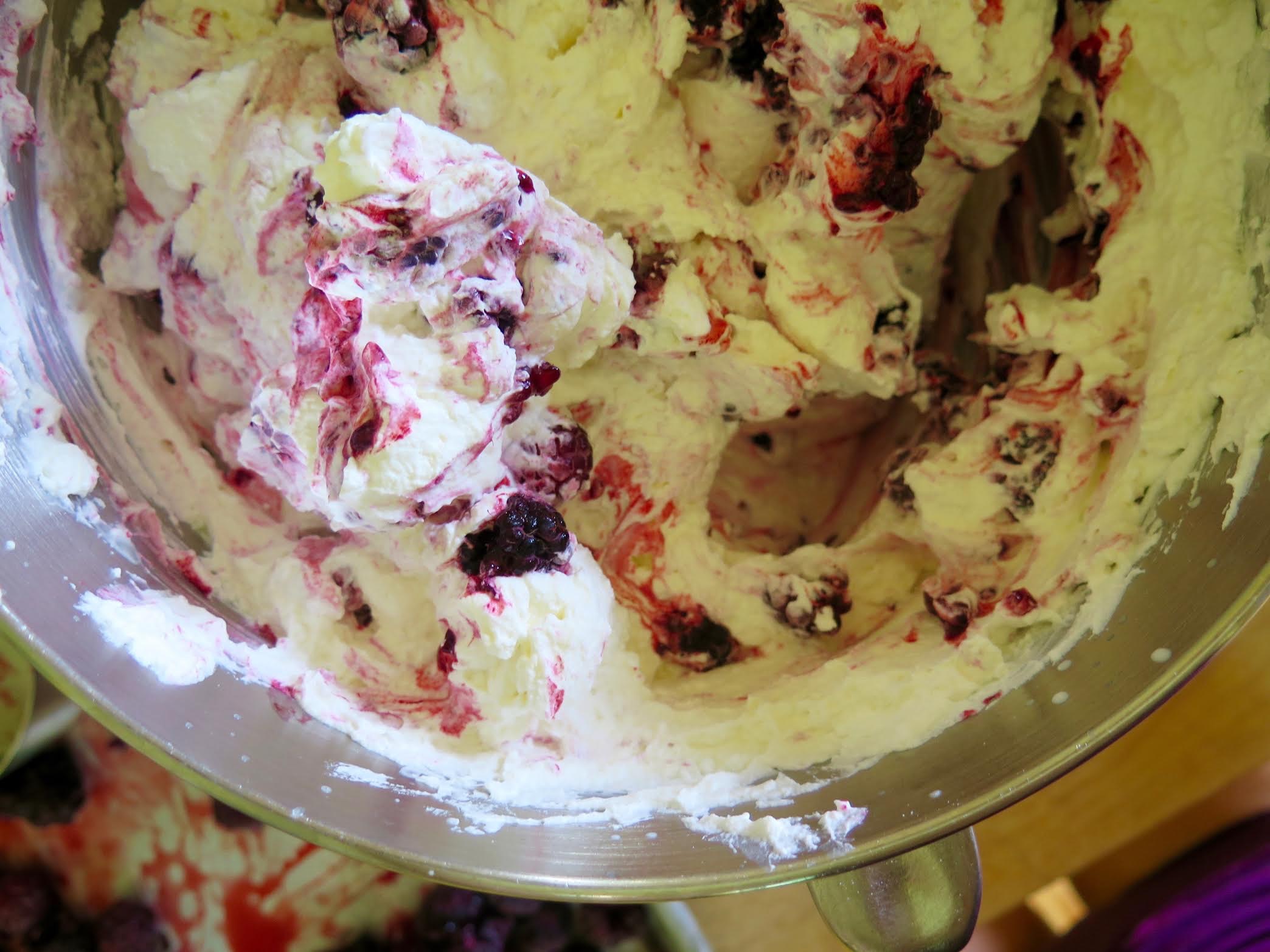 folding the black raspberries into the whipped cream